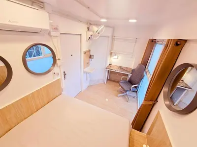 an rv with a mirror and a chair in a room at Crane nest 4 lower floor in Bangkok