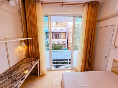 a room with a bed and a large window at Crane nest 5 townhouses view with french balcony in Bangkok