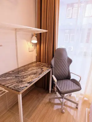 a desk and a chair in a room at Crane nest 5 townhouses view with french balcony in Bangkok