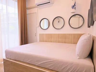 a bedroom with three mirrors above a bed at Crane nest 5 townhouses view with french balcony in Bangkok