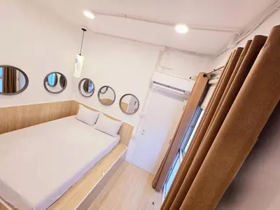 a small room with a bed and mirrors on the wall at Crane nest 6 Townhouse View in Bangkok