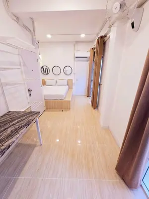 an empty room with a couch and a fan at Crane nest 6 Townhouse View in Bangkok