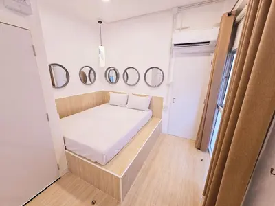 a small room with a bed and mirrors on the wall at Crane nest 6 Townhouse View in Bangkok