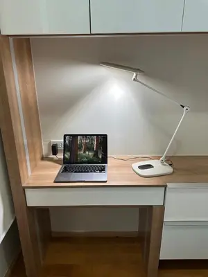 a laptop computer sitting on a desk with a lamp at New 5 STARS suite l 4 mins walk BTS&APL in Bangkok