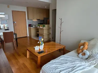 a living room with a couch and a coffee table at New 5 STARS suite l 4 mins walk BTS&APL in Bangkok