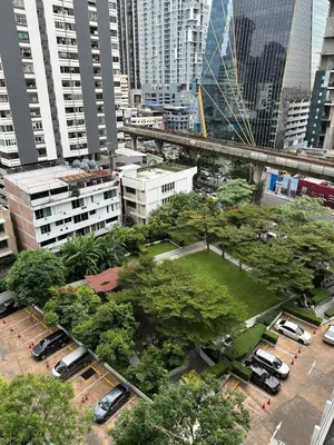 a park in the middle of a city with tall buildings at New 5 STARS suite l 4 mins walk BTS&APL in Bangkok
