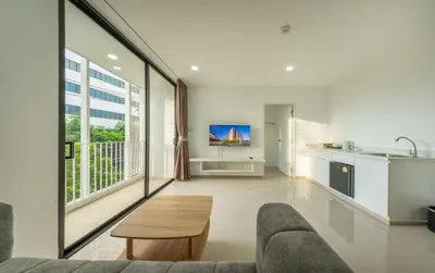 a living room with a couch and a table at SHIN Patara Living Hotel in Bangkok