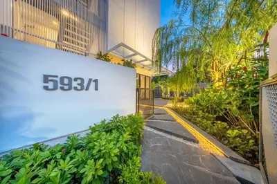 a building with a sign on the side of it at SHIN Patara Living Hotel in Bangkok