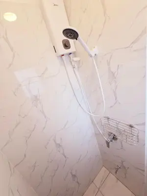 a shower in a bathroom with a shower head at Crane nest 8 townhouses view middle with balcony in Bangkok