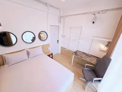 a bedroom with a bed and a chair and a mirror at Crane nest 8 townhouses view middle with balcony in Bangkok
