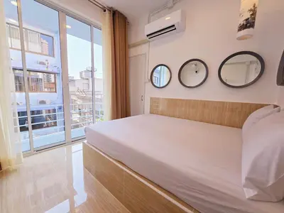 a bedroom with a bed and two mirrors on the wall at Crane nest 8 townhouses view middle with balcony in Bangkok