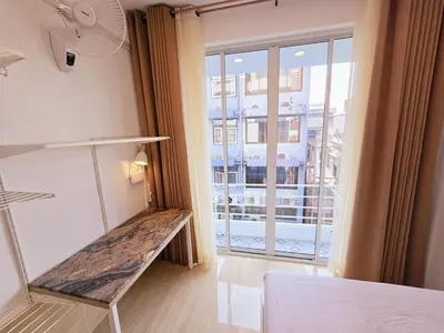 a room with a bench in front of a window at Crane nest 8 townhouses view middle with balcony in Bangkok