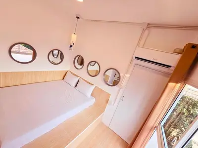 a small room with a bed and some mirrors at Crane nest 9 palm tree villa view in Bangkok