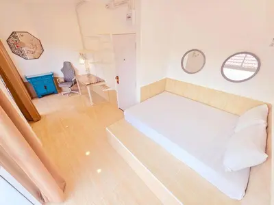 a bedroom with a white bed and a chair at Crane nest 9 palm tree villa view in Bangkok