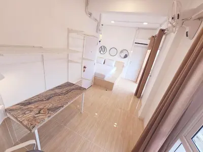 an empty room with a bed in a room at Crane nest 9 palm tree villa view in Bangkok