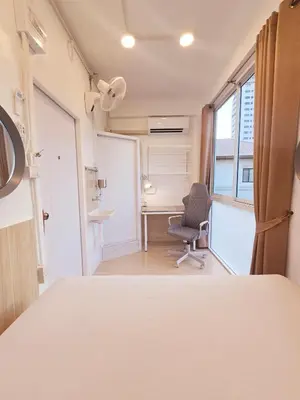 a room with a bed and a desk and a chair at Crane nest 10 banana farm view in Bangkok