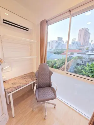 an office with a chair and a desk and a window at Crane nest 10 banana farm view in Bangkok