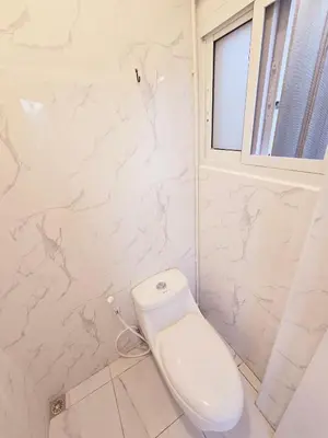 a white toilet in a bathroom with a window at Crane nest 10 banana farm view in Bangkok