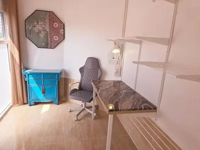 a room with a desk and a chair and a shelf at Crane nest 12 mansion view in Bangkok