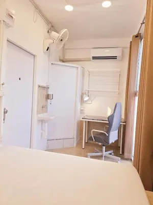 a room with a desk and a blue chair at Crane nest 13 Bangkok downtown view in Bangkok