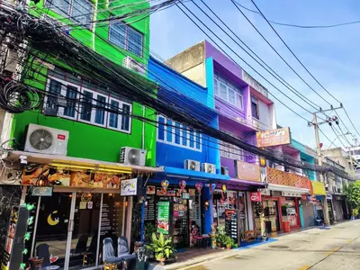 a group of buildings on a street with shops at Tropical Apartments 8 Explore Bangkok MRT Lumpini in Bangkok