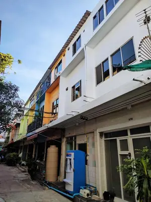 a white building with a blue utility box in front of it at Tropical Apartments 8 Explore Bangkok MRT Lumpini in Bangkok