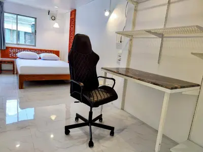 a desk and a chair in a room with a bed at Tropical Apartments 8 Explore Bangkok MRT Lumpini in Bangkok
