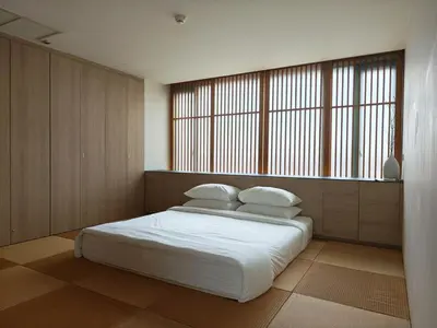 a bedroom with a bed with white sheets and pillows at Japanese Style 1-Bedroom 162m BTS Thonglor-Ekmai \u7af9 \u30ec\u30b8\u30c7\u30f3\u30b9 in Bangkok