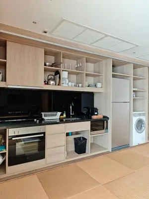 a kitchen with wooden cabinets and a refrigerator at Japanese Style 1-Bedroom 162m BTS Thonglor-Ekmai \u7af9 \u30ec\u30b8\u30c7\u30f3\u30b9 in Bangkok