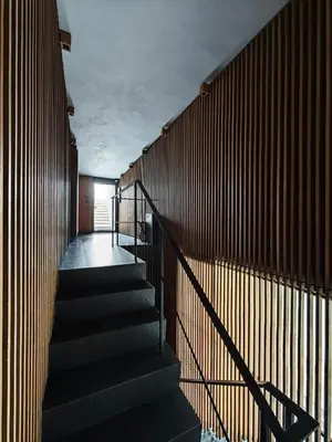 a staircase in a building with a wooden wall at Japanese Style 1-Bedroom 162m BTS Thonglor-Ekmai \u7af9 \u30ec\u30b8\u30c7\u30f3\u30b9 in Bangkok