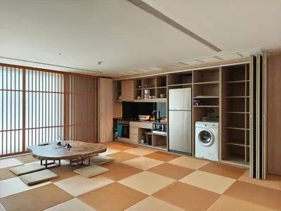 a living room with a table and a refrigerator at Japanese Style 1-Bedroom 162m BTS Thonglor-Ekmai \u7af9 \u30ec\u30b8\u30c7\u30f3\u30b9 in Bangkok