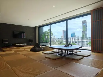 a living room with a table and a large window at Japanese Style 1-Bedroom 162m BTS Thonglor-Ekmai \u7af9 \u30ec\u30b8\u30c7\u30f3\u30b9 in Bangkok