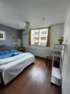 a bedroom with a bed and a ladder in it at Santo house Bangkok in Bangkok
