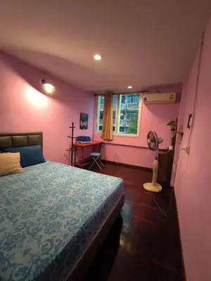 a bedroom with a bed and a window and a fan at Santo house Bangkok in Bangkok
