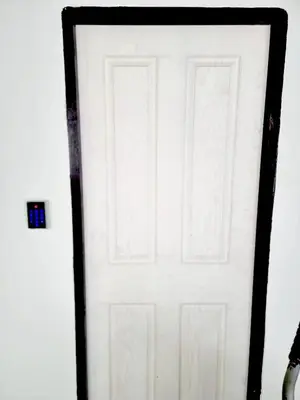 a white door with a black frame in a room at XX Mitr inn Khaosan มิตร อินน์ ถนนข้าวสาร 2 in Bangkok