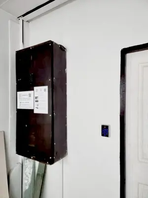 a box on the side of a wall next to a door at XX Mitr inn Khaosan มิตร อินน์ ถนนข้าวสาร 2 in Bangkok