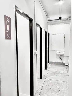 a hallway with a bathroom with a toilet in it at XX Mitr inn Khaosan มิตร อินน์ ถนนข้าวสาร 2 in Bangkok