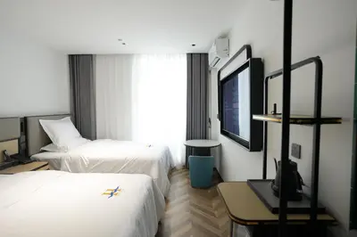 a hotel room with two beds and a tv at Haiman Hotel\u6d77\u66fc\u9152\u5e97 in Bangkok
