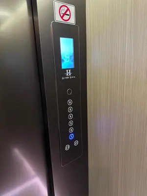 a elevator button with a no smoking sign on it at Haiman Hotel\u6d77\u66fc\u9152\u5e97 in Bangkok