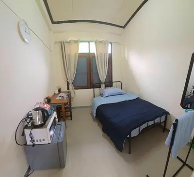 a small room with a bed and a table at 212 Cozy room with private balcony in Bangkok