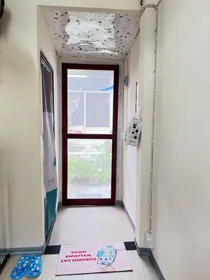 an empty hallway with a door and a window at 212 Cozy room with private balcony in Bangkok