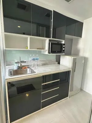 a kitchen with a sink and a microwave at The Room Sukhumvit 64 Punnawithi in Phra Khanong