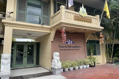 a building with a sign on the side of it at Suan Sunandha Palace Hotel in Bangkok