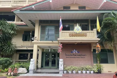 a building with flags on the front of it at Suan Sunandha Palace Hotel in Bangkok