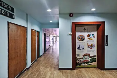 a hallway with a door in a building with a hallway at Suan Sunandha Palace Hotel in Bangkok