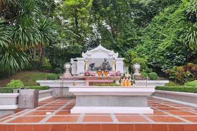 a statue in the middle of a garden at Suan Sunandha Palace Hotel in Bangkok