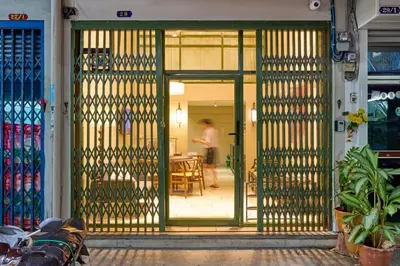 an open door with a person in the background at Newly Renovated, 4BR Townhouse , 5min MRT , Group in Bangkok