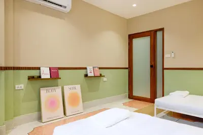 a room with two beds and a door and shelves at Newly Renovated, 4BR Townhouse , 5min MRT , Group in Bangkok