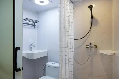 a bathroom with a shower and a toilet and a sink at Newly Renovated, 4BR Townhouse , 5min MRT , Group in Bangkok
