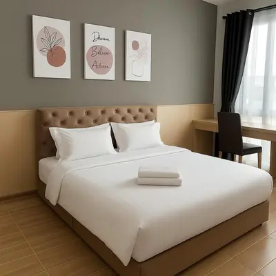 a bedroom with a large white bed and a desk at 3BR max 9pax near MRT Ratchada Good for group in Bangkok